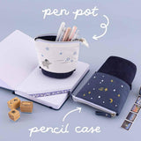 Tsuki ‘Dreams of Snow’ Pop-Up Pencil Cases in Starry Night and Playful Penguin which double as a pen pot on open bullet journal spread with Tsuki ‘Dreams of Snow’ Bullet Journal Stamps and Tsuki ‘Dreams of Snow’ Holographic Washi Tapes on light blue background